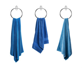Hanged Blue towel in a round chrome towel holder. Isolated transparent PNG. Collection of fluffy soft cotton towels hanged on a towel ring. Hand towel. Bath towel. Hand Towel.