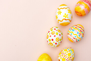 Easter background. Handmade painted eggs lie on a pink background. - 742750234