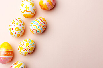 Easter background. Handmade painted eggs lie on a pink background. - 742750240