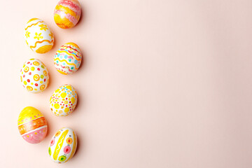 Easter background. Handmade painted eggs lie on a pink background.