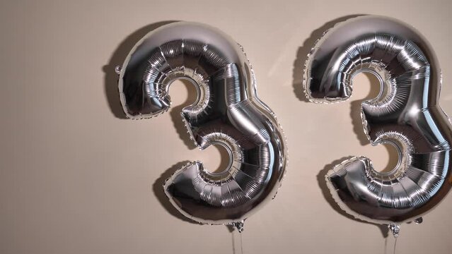 Party Happy Birthday Thirty-Three with Silver Grey number . Gel balls 33 for congratulations celebrations holiday. Close-up, no people