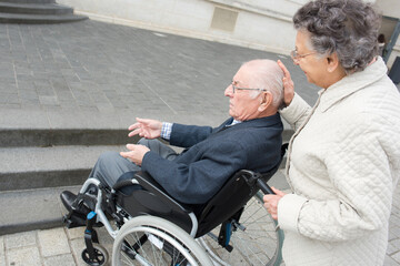a senior couple in wheelchair
