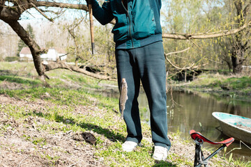 A man with his catch.
A man with a recently caught fish