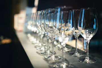 The row of empty wine glasses waiting for the beginning of the soiree,