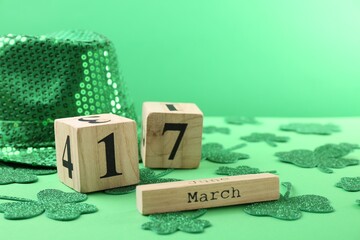 St. Patrick's day - 17th of March. Wooden block calendar, leprechaun hat and decorative clover...