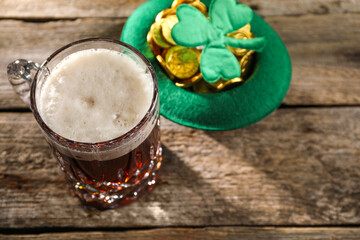 St. Patrick's day celebration. Green beer, leprechaun hat with gold and decorative clover leaf on...