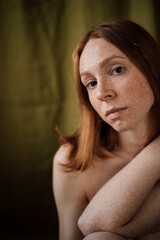 Fototapeta premium red-haired girl with freckles with mimosa