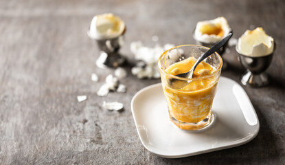 Soft-boiled eggs in a glass cup for breakfast. - 742778644