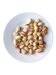 A pile of pistachios on a white plate.