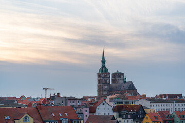 Fototapeta premium View from the parking garage at the seaport towards Stralsund old town Saint Nikolai Church at sunset; Stralsund; Germany