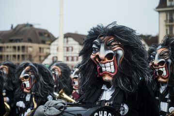 Basel - Switzerland - 21 February 2024 - portrait of masked people wearing traditional costume playing music parading in the street
- 742789204