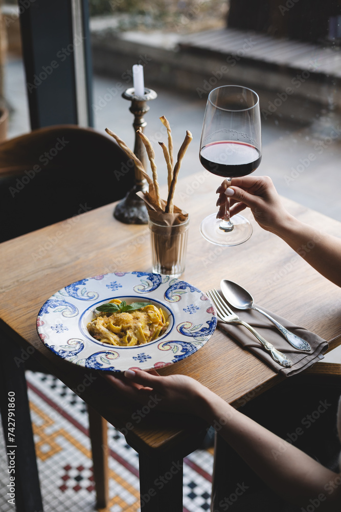 Wall mural italian pasta with cheese sauce and basil in a vintage plate.