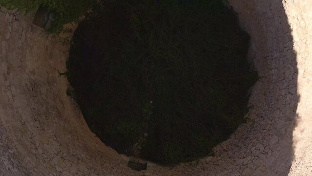 Aerial view looking at a nevera (snow pit) these snow pits were used in antiquity to preserve the fallen snow, Cava Don Miguel, Mariola mountain, Alicante, Spain - stock video