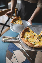 Appetizing Italian cheese pizza. A slice of pizza with a mix of cheeses.