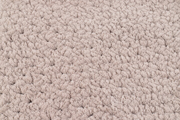 Beige soft and fluffy knitted texture, background