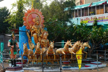 statue of god krishna riding on horse cart