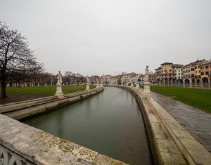 Historical canal in Padova, Veneto, Italy, adorned with charming monuments, showcasing the rich...