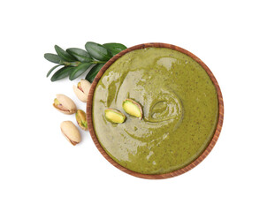 Tasty pistachio cream in bowl, leaves and nuts isolated on white, top view