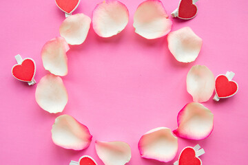 Round frame of rose petals on pink background. Love concept