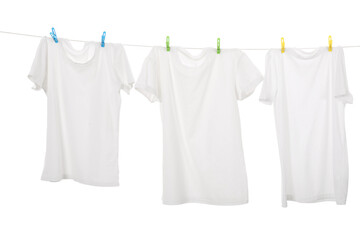 Many t-shirts drying on washing line isolated on white