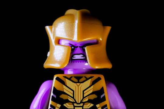 Face of LEGO Marvel's Thanos on a black background. Thanos in a yellow suit and helmet