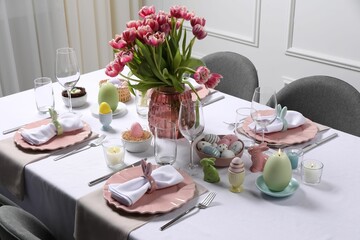 Festive table setting with beautiful flowers. Easter celebration