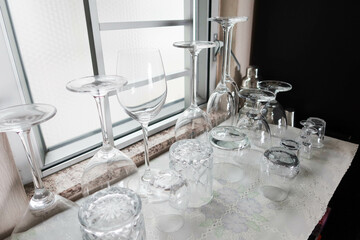 close up of wine, sake, drinks glasses by the window upside down on the counter