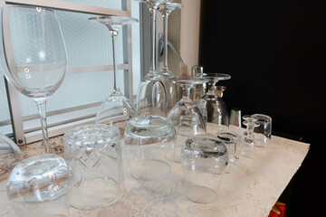 close up of wine, sake, drinks glasses by the window upside down on the counter