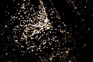Golden and silver blurred bokeh lights on black background. Glitter sparkle stars for celebrate. Overlay for your design