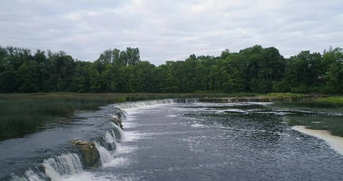 Aerial drone slow motion shot of Europe's widest waterfall Venta rapid, Kuldīga, Latvia