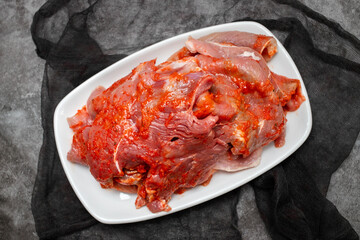 sliced raw pork meat on white dish