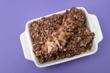 Typical portuguese dish chicken with rice on dish.