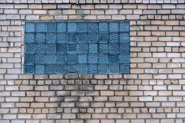 Old aged brick wall with window made of glass blocks.Old glass block wall texture, frosted glass brick wall background.