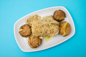 Traditional portuguese cousine, cod fish with potatoes and onions, covered with oil.