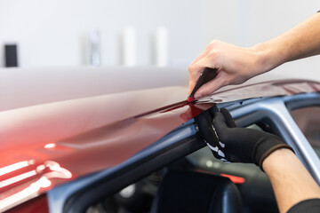 Process of gluing or wrapping a new foil wrap to a car, car detailing concept