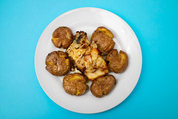 Traditional portuguese cousine, cod fish with potatoes and onions, covered with oil.