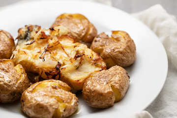 Traditional portuguese cousine, cod fish with potatoes and onions, covered with oil.