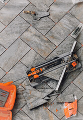 Tiler's tools during flooring installation. Tile cutters, spacers and other accessories.