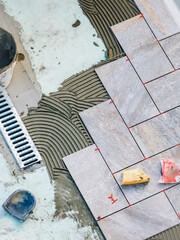 Laying garden paving with all the tools necessary for the tiler.