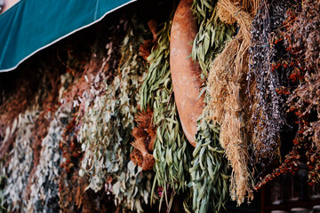 Exotic dried herbs hanging on moroccan street market.