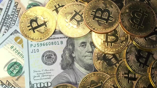 Golden physical Bitcoin coins on US dollars close up, rotating money background. Electronic crypto currency. Savings and investments concept. - Powered by Adobe