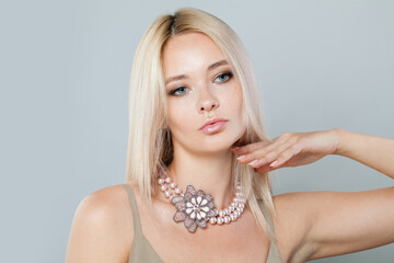 Lovely fashion jewelry model woman. Lady with fresh clean skin, blonde hair and necklace on her neck