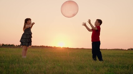 Girl Child Boy Kid playing big ball sunset, children dream flying, happy family, filled with...