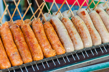 Thai Style Grilled Sausage (Sai Krok Isan) on stove.