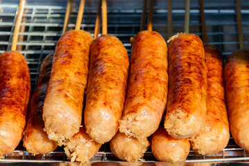 Thai Style Grilled Sausage (Sai Krok Isan) on stove. - obrazy, fototapety, plakaty