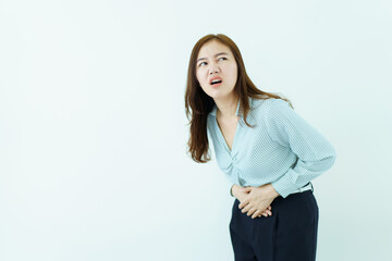 Asian woman in business casual wardrobe touching on her belly or stomach painfully. Woman having a...