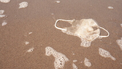 photo of mask waste on the beach