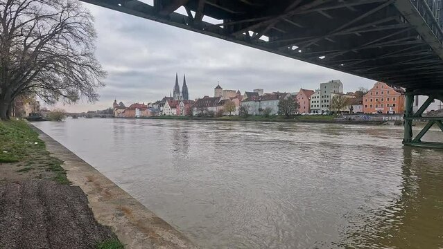 Regensburg with the Danube at flooding with a view of the cathedral and the stone bridge