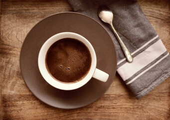 Cup of coffee on rustic wooden background. Soft focus. Close up. Copy space