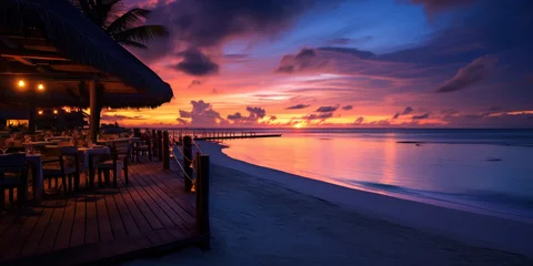 Foto op Canvas Maldives at a resort on the island at sunset. © Wararat
